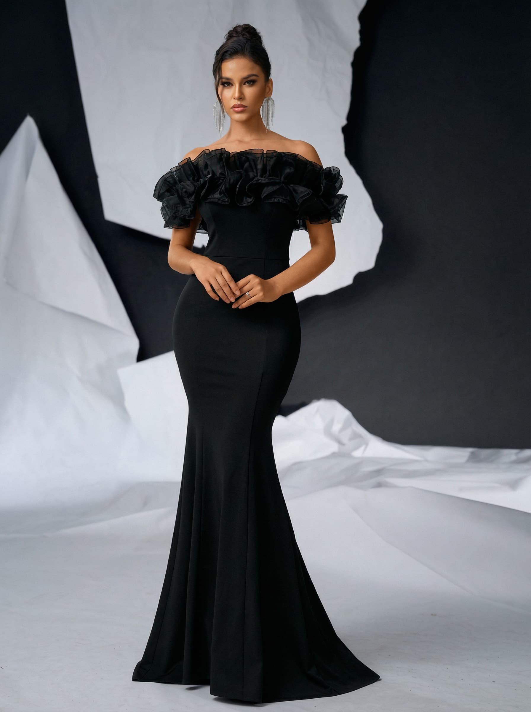 a hight fashion quality model wearing a maxi off sholder black dress