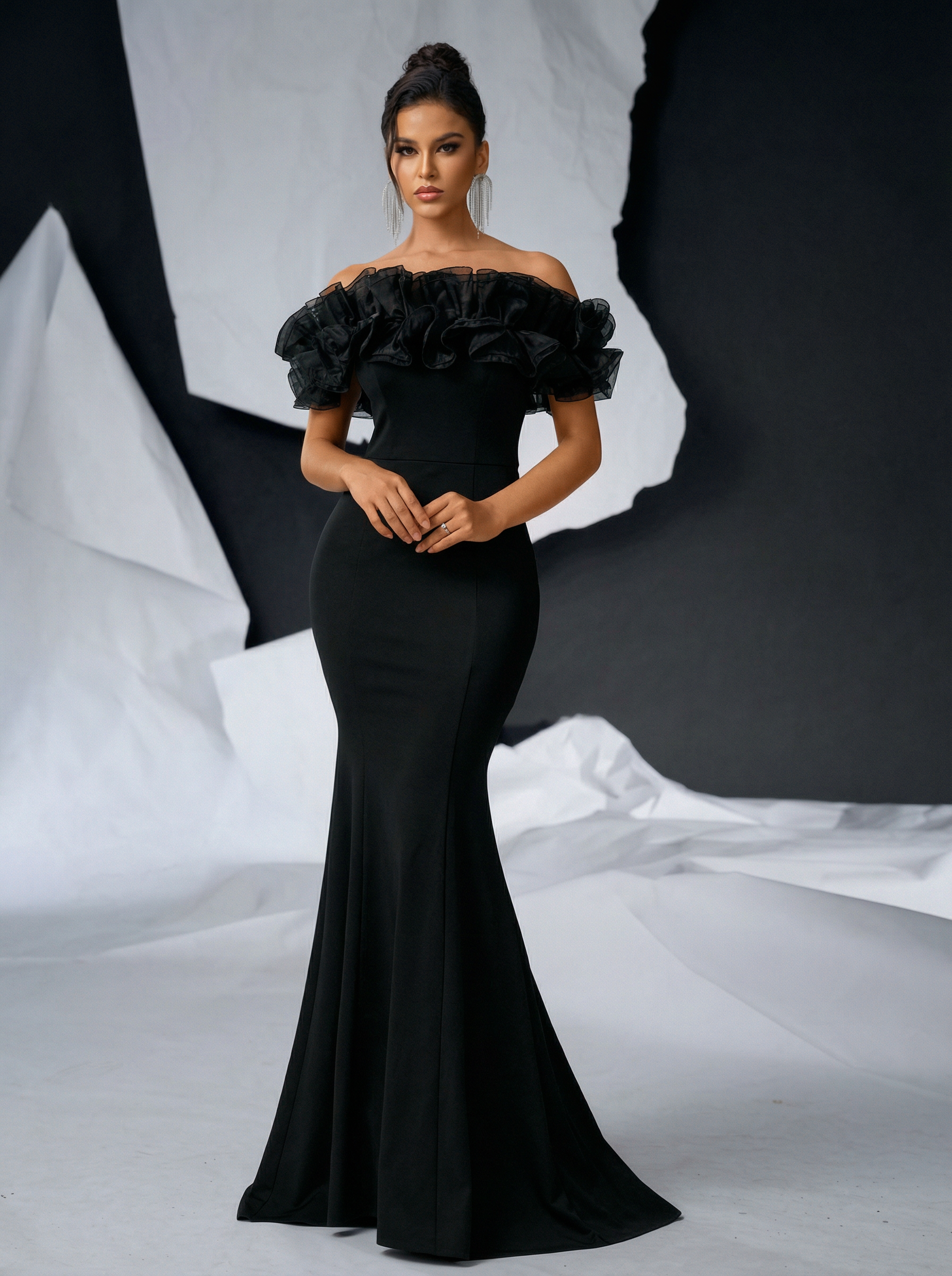 a hight fashion quality model wearing a maxi off sholder black dress