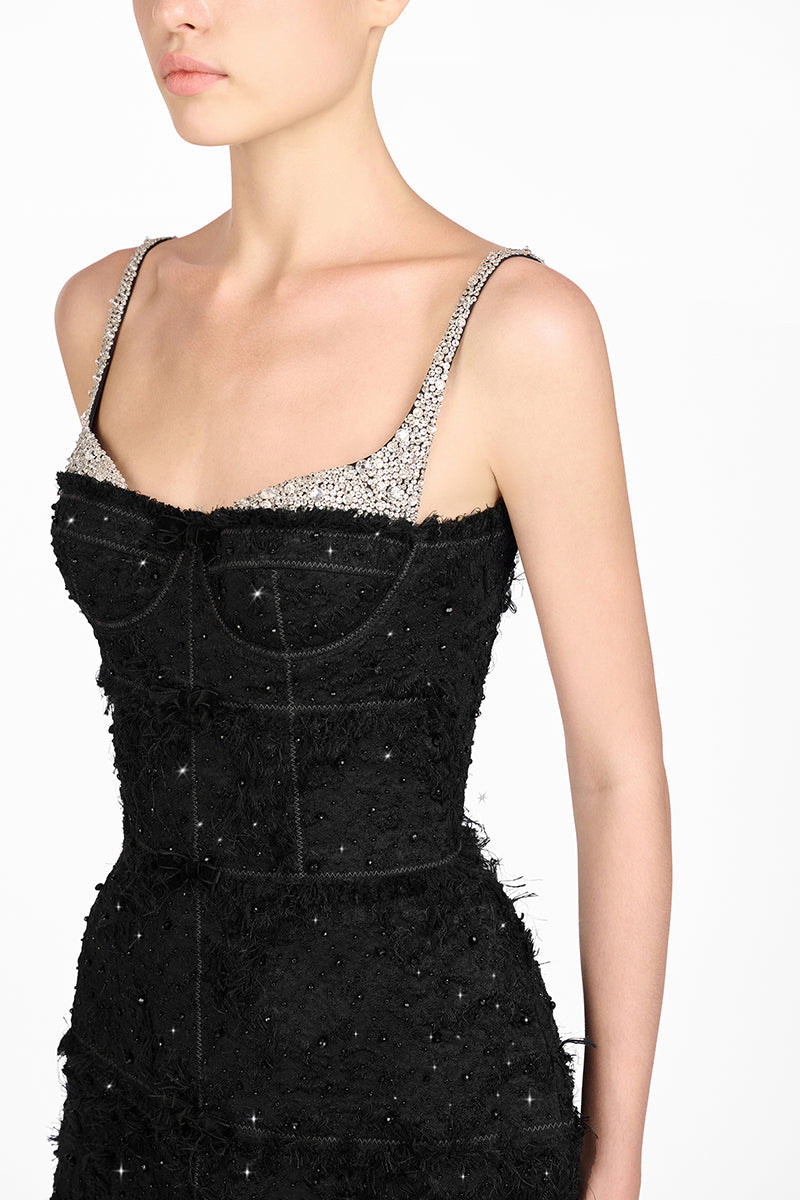 Black dress with silver embellishments on a white background