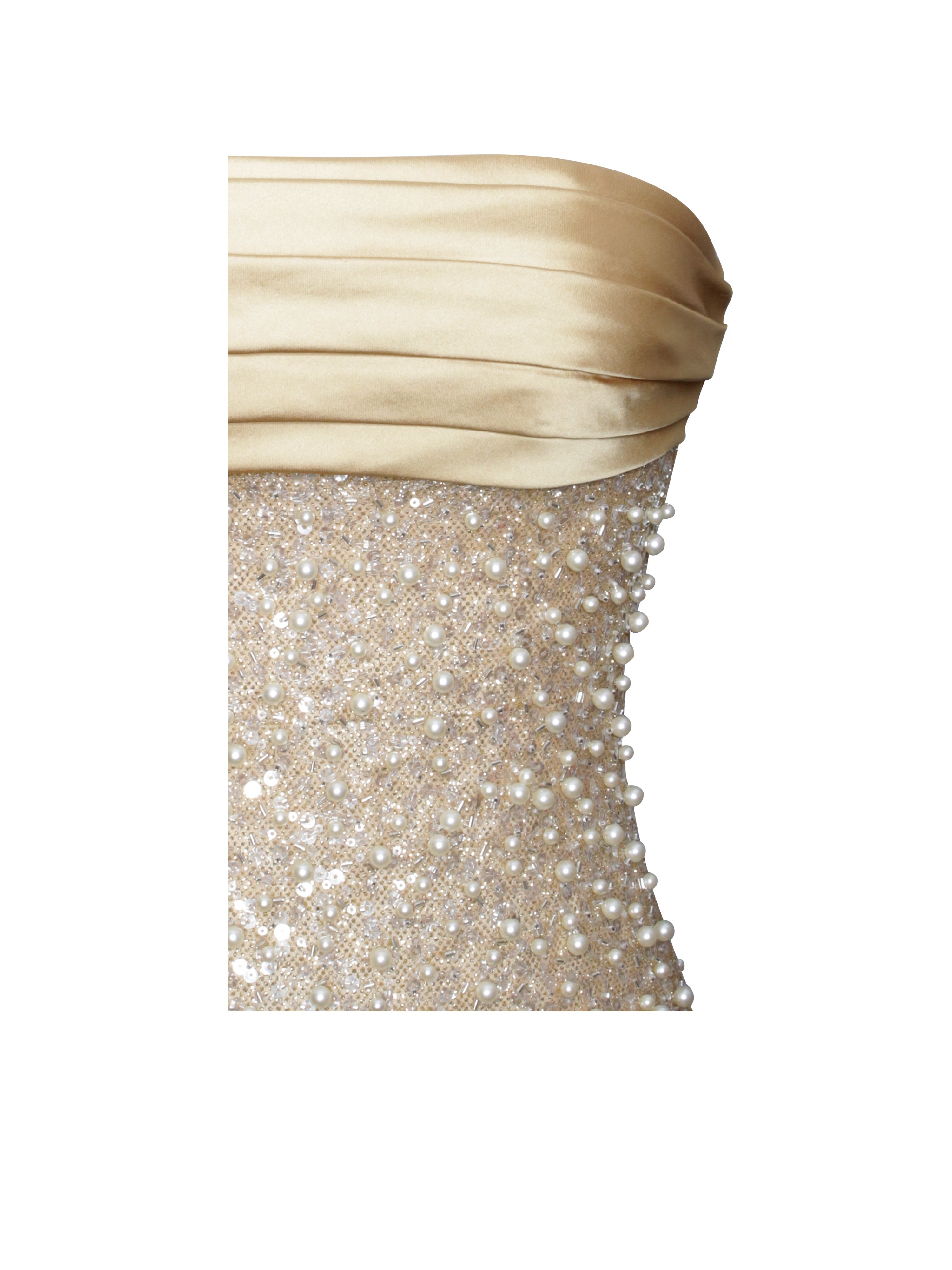 Beige strapless top with glittery silver skirt on a white background