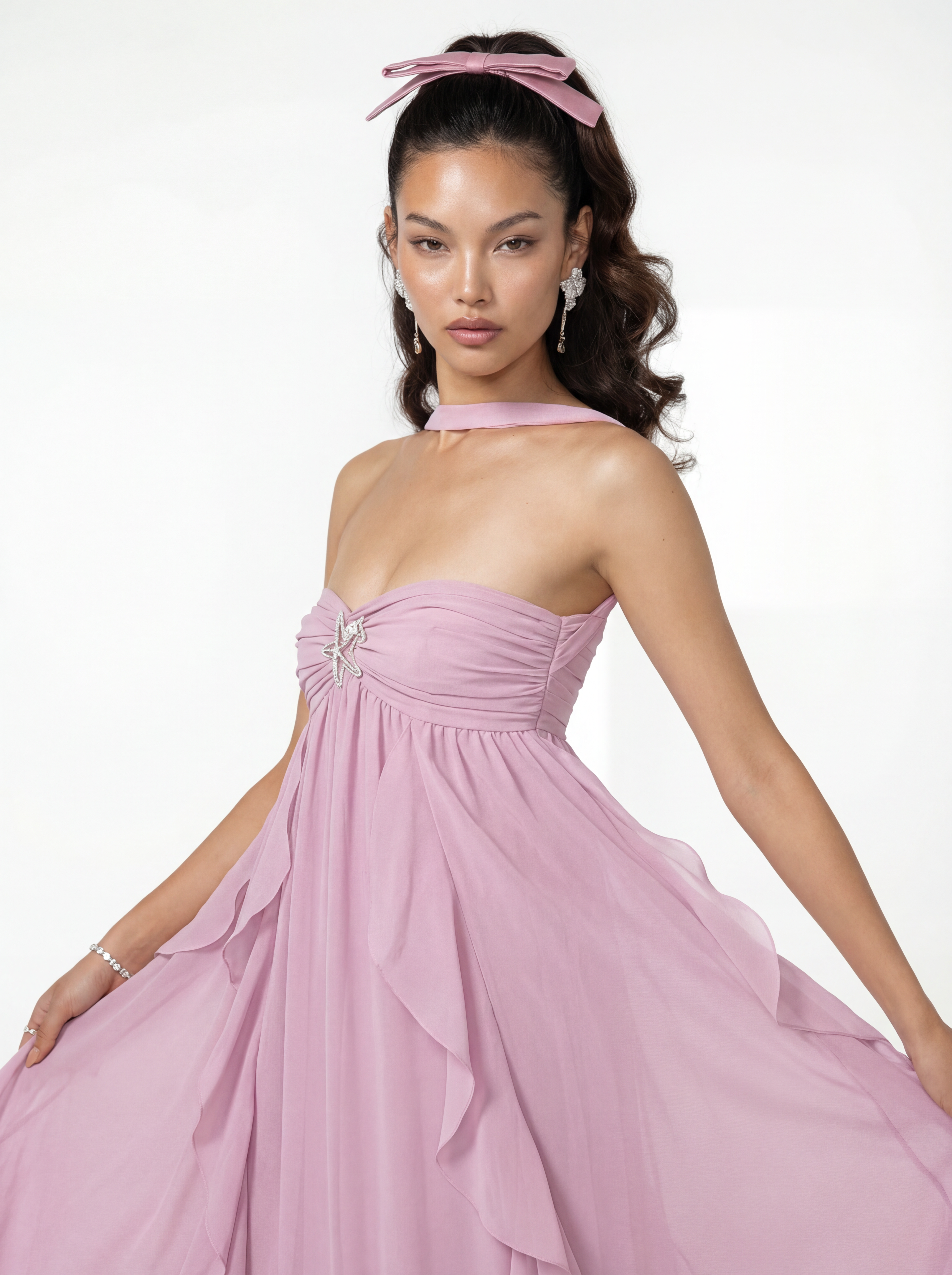 Woman wearing a pink gown with a white background