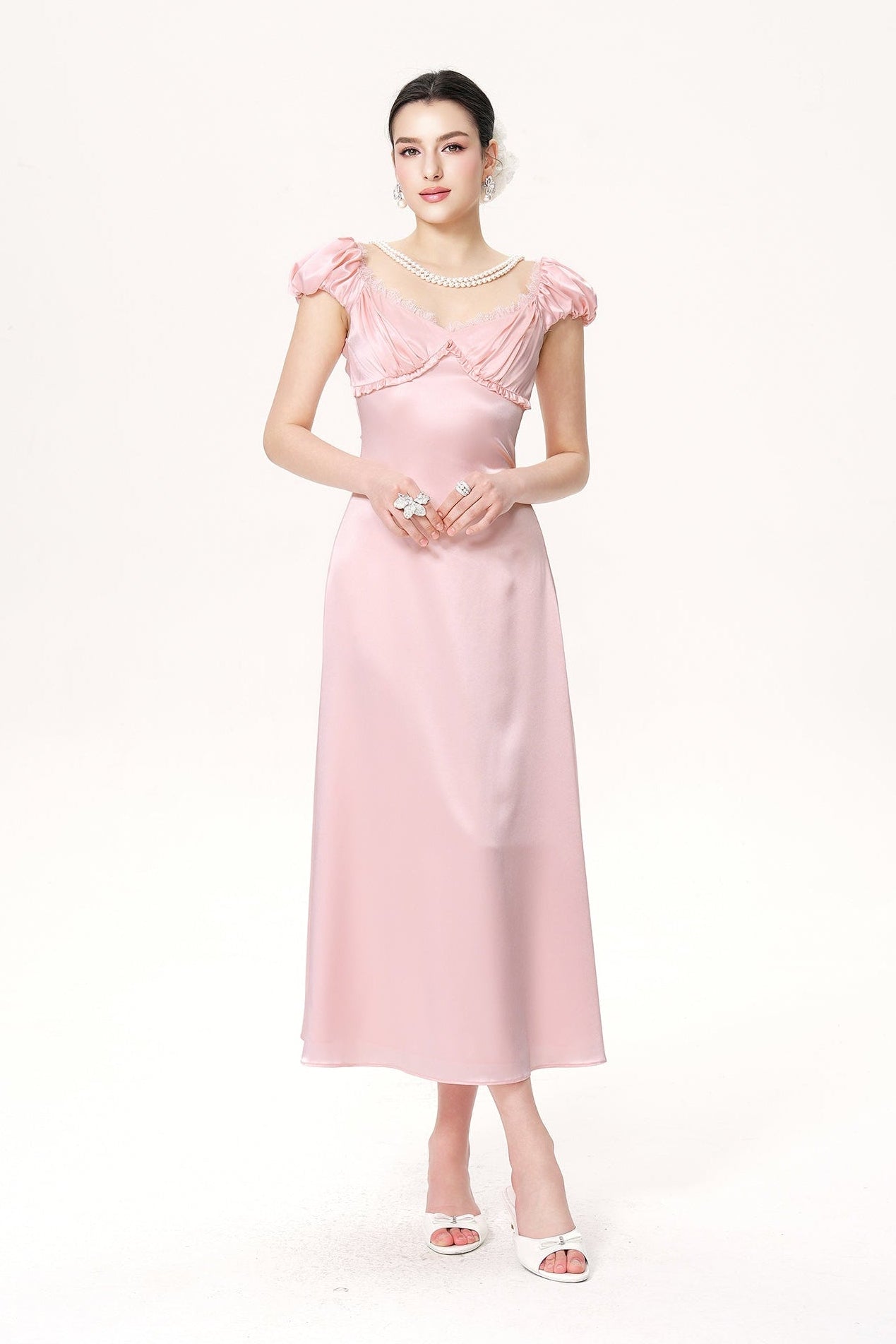 Woman wearing a pink dress on a white background