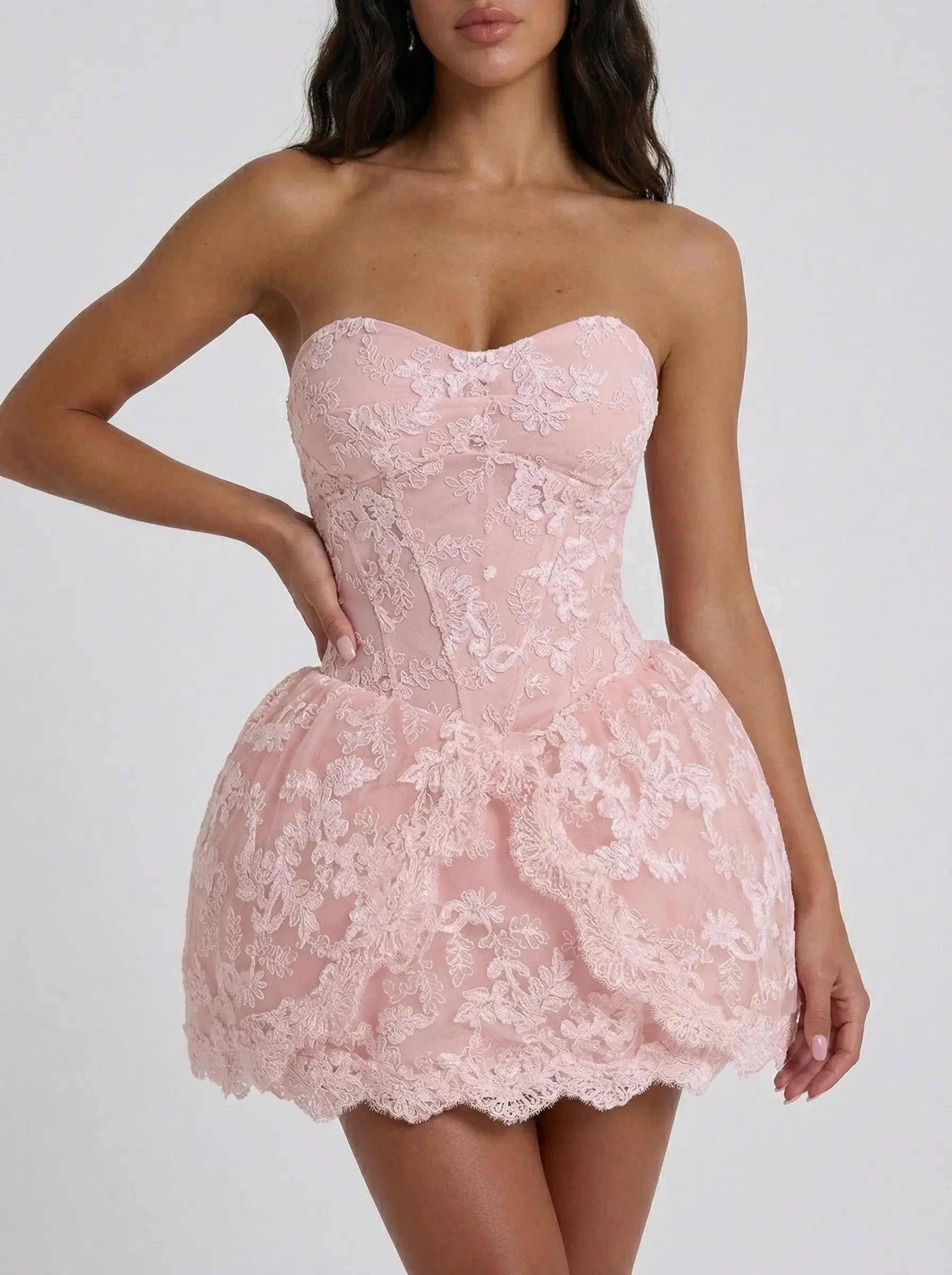 Pink lace strapless dress on a plain background