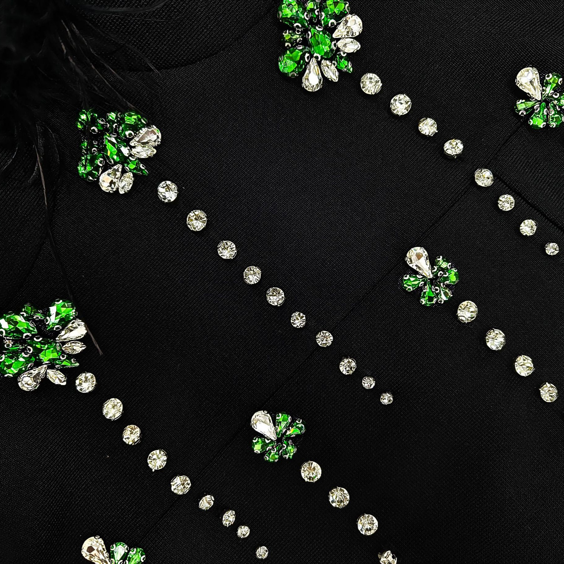 Black fabric with green and silver gemstone embellishments