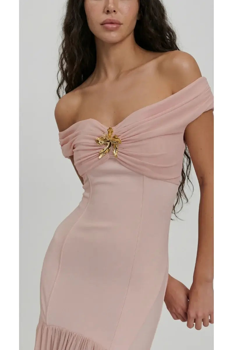 Pink off-shoulder dress with a floral embellishment on a white background
