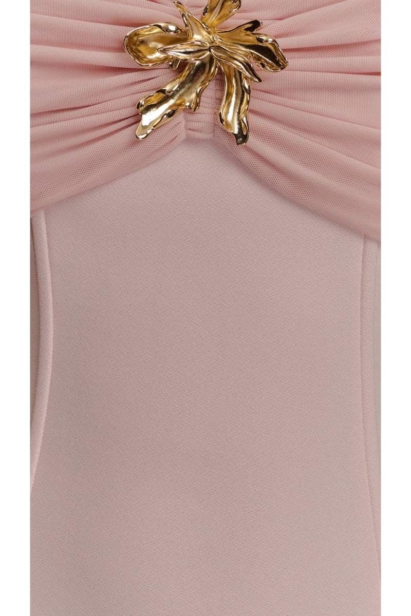 Pink dress with a gold bow detail on a white background