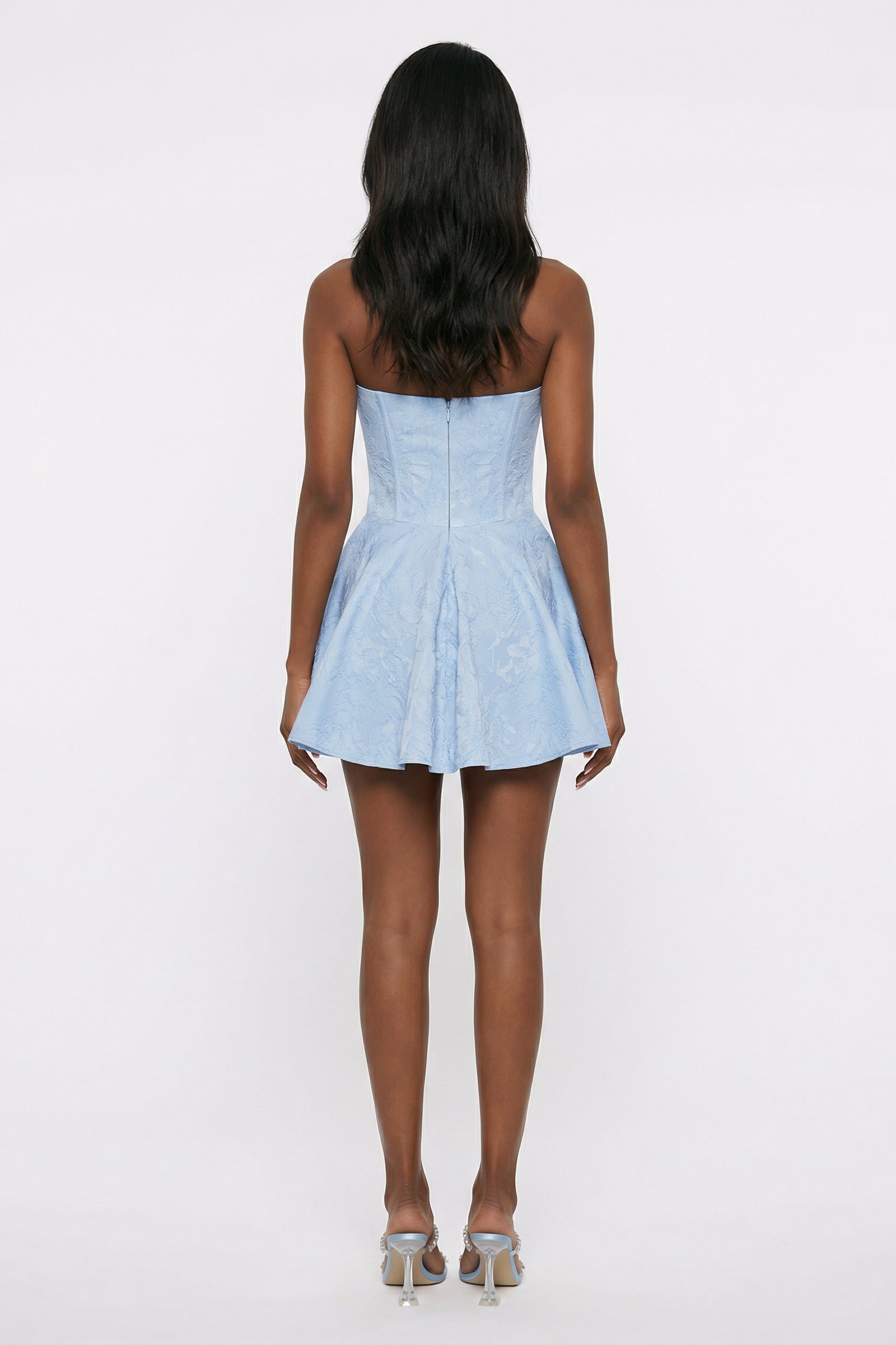 Light blue strapless dress worn by a person on a white background