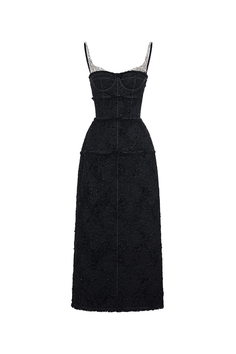 Black textured dress with silver straps on a white background