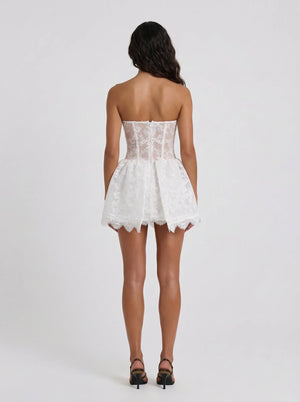 White lace strapless dress worn by a model on a white background