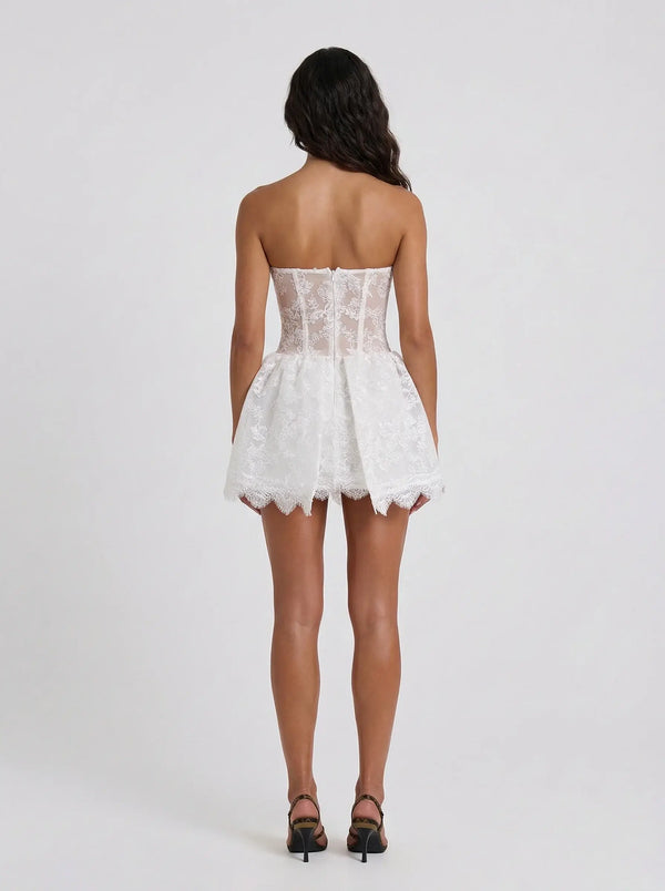 White lace strapless dress worn by a model on a white background