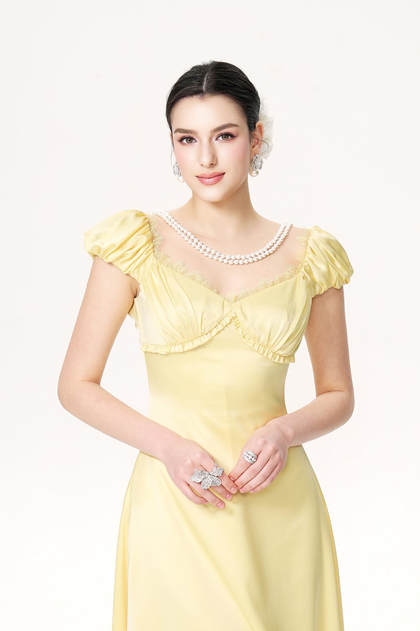 Woman wearing a yellow dress with a white background