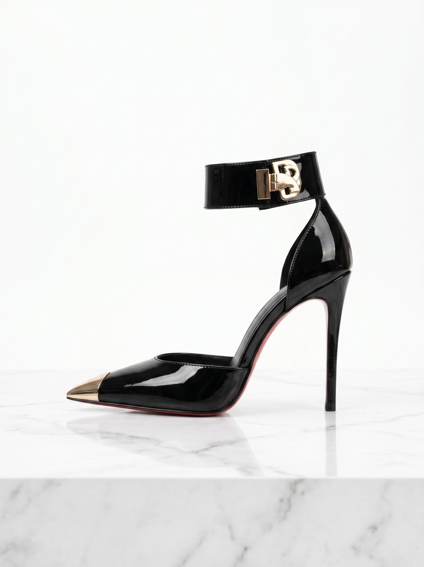 Black high-heeled shoe with gold accents on a white marble surface