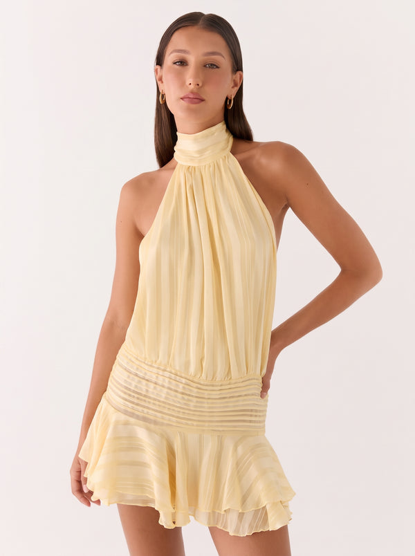 Backless Halter Ruffle Mini Dress in buttermilk yellow, close-up three-quarter view on model, VeroMarka