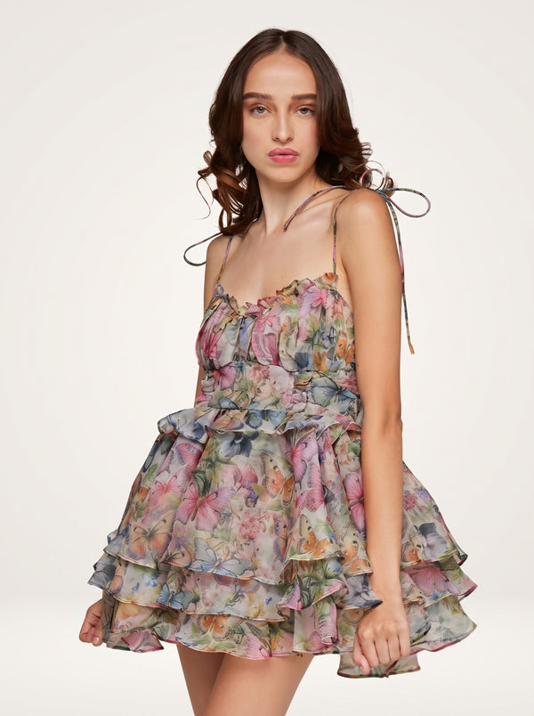Butterfly Floral Tiered Mini Dress in pastel floral, three-quarter view on model, VeroMarka