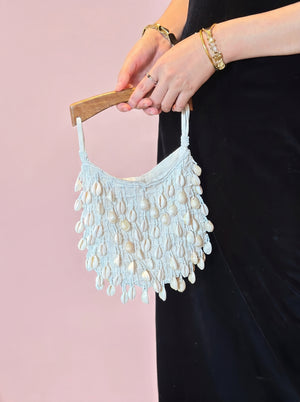 Cowrie Shell Wooden Tote in ivory — cowrie shell fringe and wooden handle, held by the wooden handle, VeroMarka