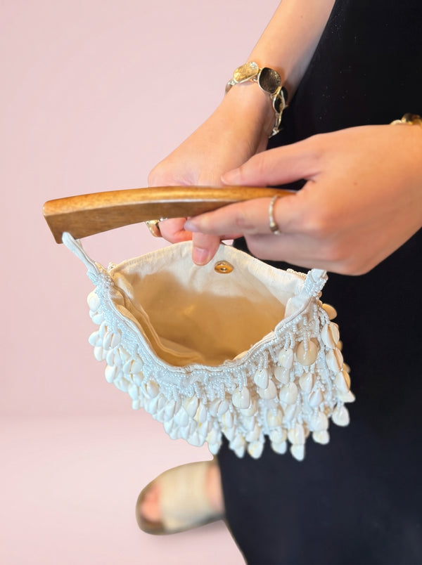 Cowrie Shell Wooden Tote in ivory — cowrie shell fringe and wooden handle, open to show the lining, VeroMarka