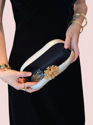 Pearl Coral Clasp Clutch in pearl white — pearlescent shell and gold coral clasp, open to show the satin lining, VeroMarka