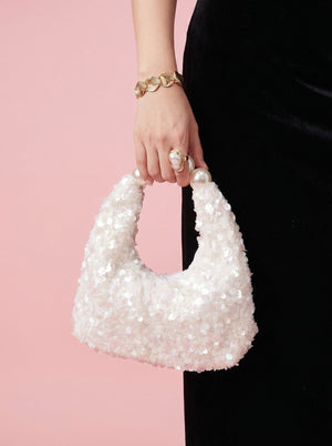 Pearl Handle Sequin Bag in white — sequin finish and pearl handle, held at the side, VeroMarka