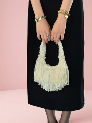 Pearl Tassel Underarm Bag in ivory pearl — beaded pearl handle and pearl tassel fringe, held in both hands, VeroMarka