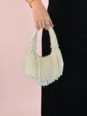Pearl Tassel Underarm Bag in ivory pearl — beaded pearl handle and pearl tassel fringe, held by the handle, VeroMarka