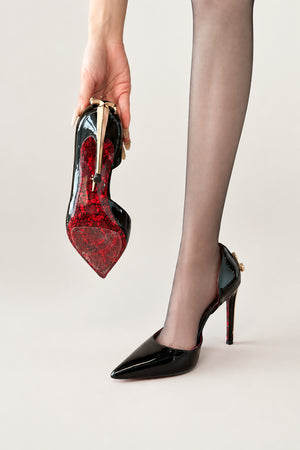 Pointed Stiletto Sword Pump in black — gold dagger heel and red lace-print sole, black pump held in hand, VeroMarka