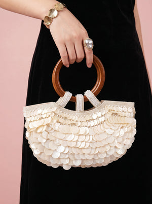 Sequin Shell Ring-Handle Bag in ivory, held by the ring handle, alternate shot, VeroMarka