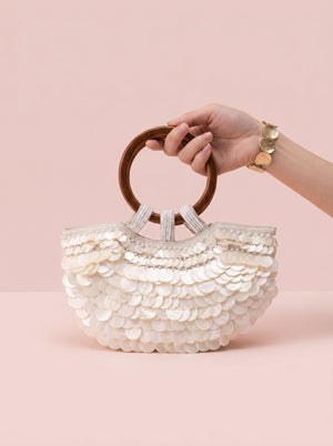 Sequin Shell Ring-Handle Bag in ivory — shell sequins and wooden ring handle, held by the wooden ring handle, VeroMarka