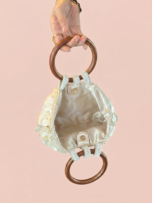 Sequin Shell Ring-Handle Bag in ivory — shell sequins and wooden ring handle, open to show the lined interior, VeroMarka