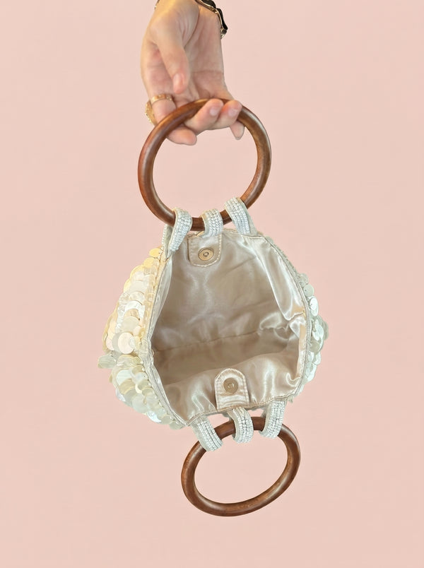 Sequin Shell Ring-Handle Bag in ivory — shell sequins and wooden ring handle, open to show the lined interior, VeroMarka