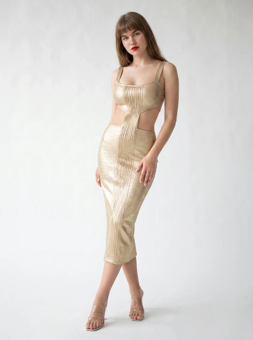 SeraphinaGold Metallic Cut-Out Midi Dress in gold — cut-out waist and back slit, three-quarter view on model, VeroMarka