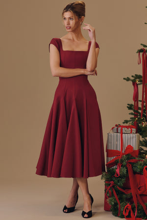 Square Neck A-Line Midi Dress in burgundy, standing beside a Christmas tree, VeroMarka
